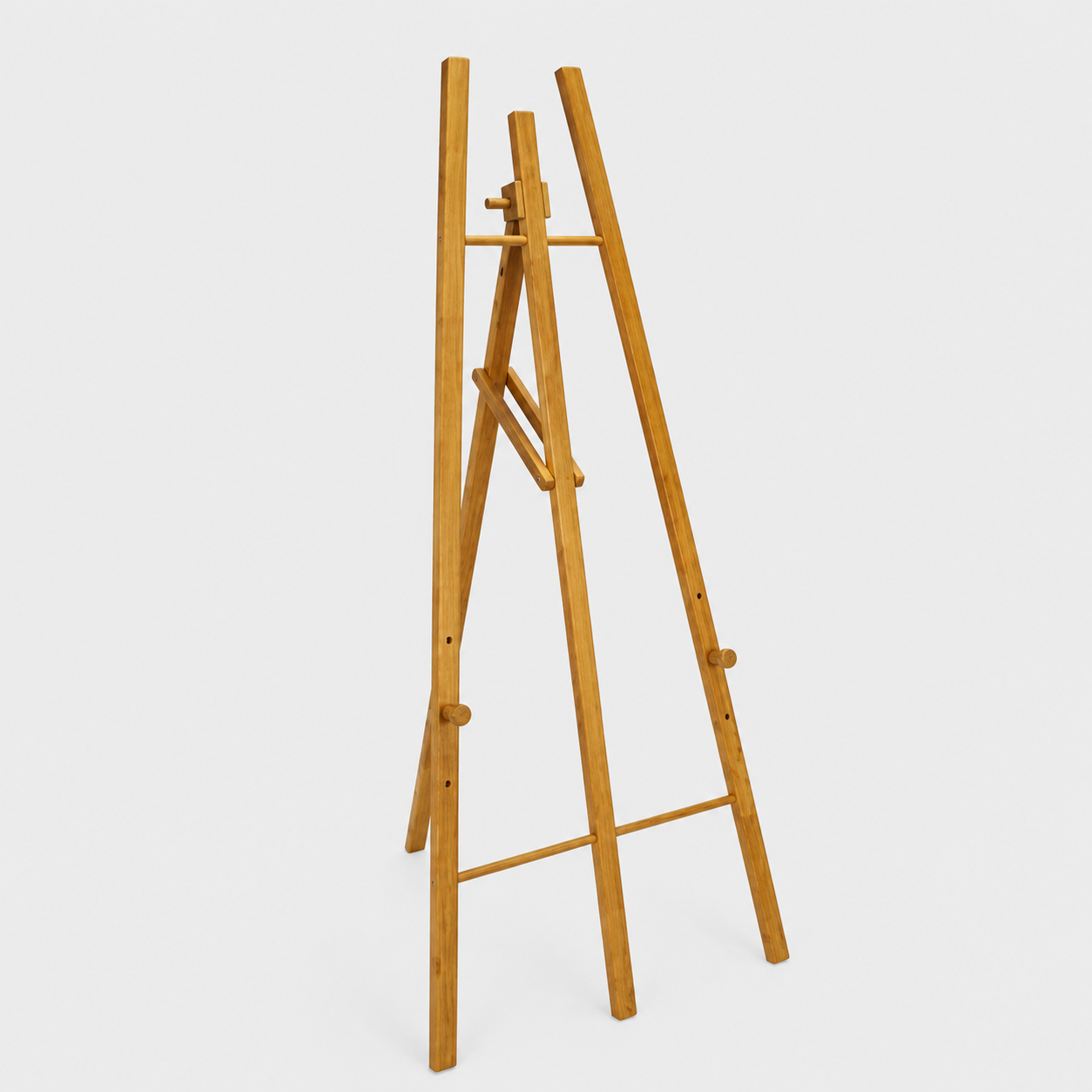 Wooden artist easel with adjustable legs standing upright on a white background