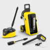 Yellow and black Karcher K7 premium pressure washer with hose reel and accessories including spray gun, wand, and nozzle attachments laid out nearby