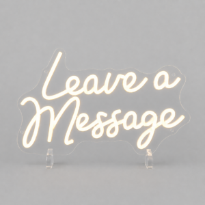 Neon sign that reads 'Leave a Message' in cursive, mounted on a gray backdrop with clear stands nearby (decorative display).
