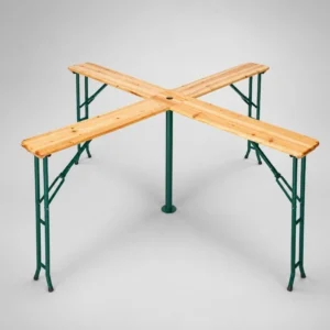 Outdoor wooden picnic table with four benches arranged in an X shape around a central supporting post with green metal legs.