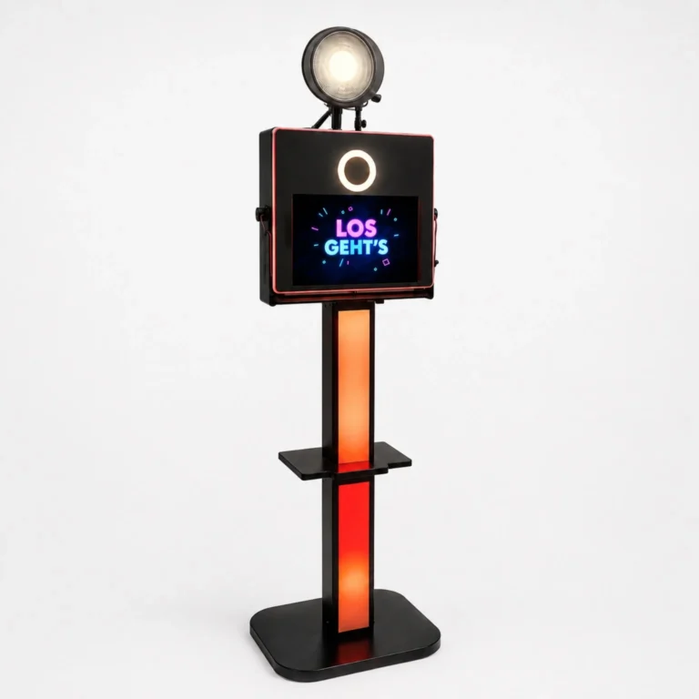 Photo booth on a stand with a circular ring light and a touchscreen displaying 'LOS GEHT'S'.