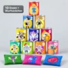 Pyramid of 10 colorful cans numbered 1–10 with knights, wizard, and dragon artwork; three decorative cushions in front (bean bags).